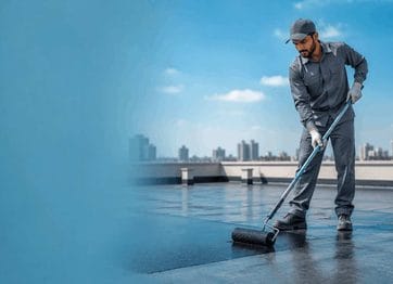 Expert technician applying professional waterproof membrane coating on a Dubai commercial rooftop